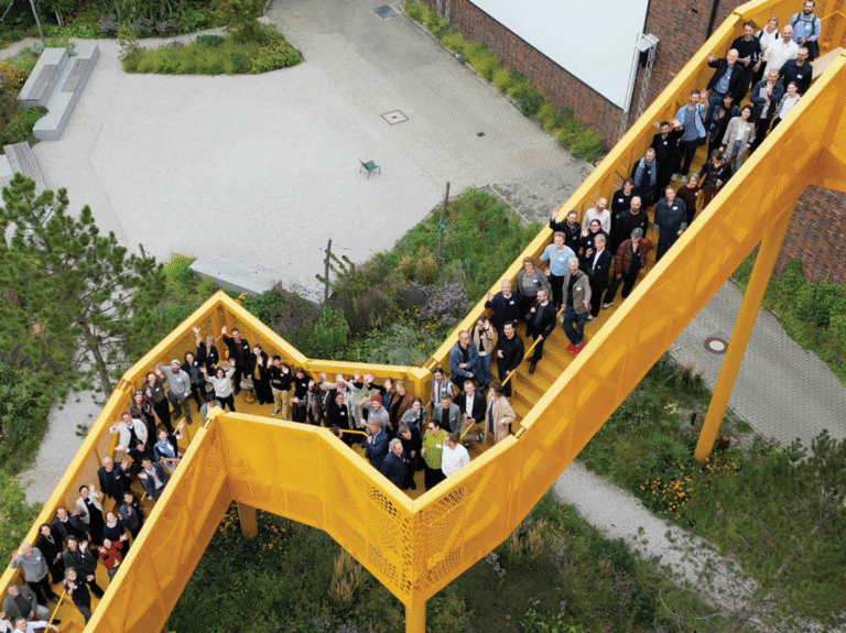 The Bauhaus Earth team gathered on the yellow bridge at Atelier Gardens, driving systemic change in the built environment.