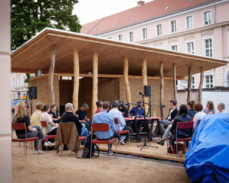 Community workshop taking place at the ProtoPotsdam demonstrator, a regenerative building prototype made of earth and timber.